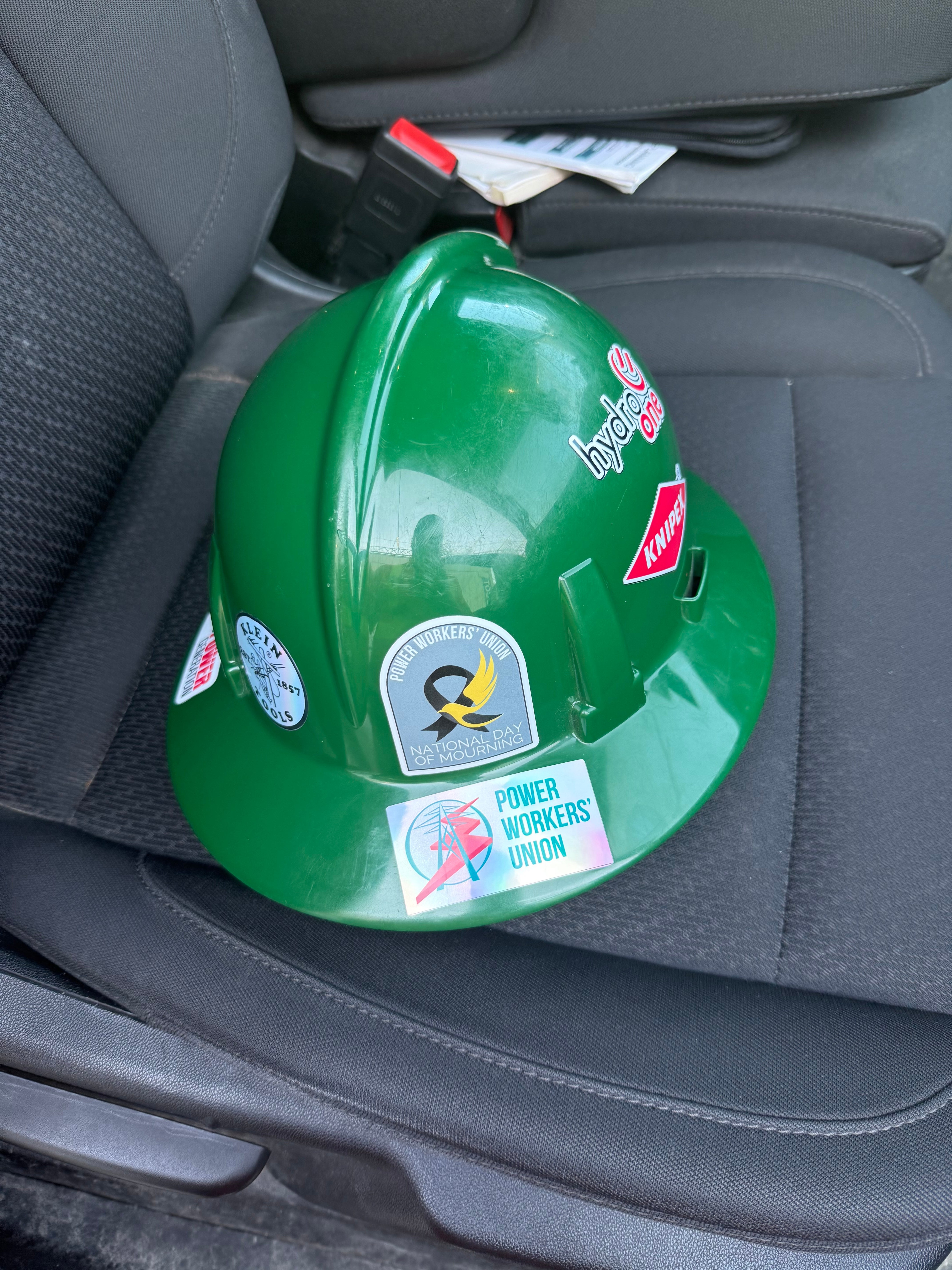 Custom stickers on a green hard hat