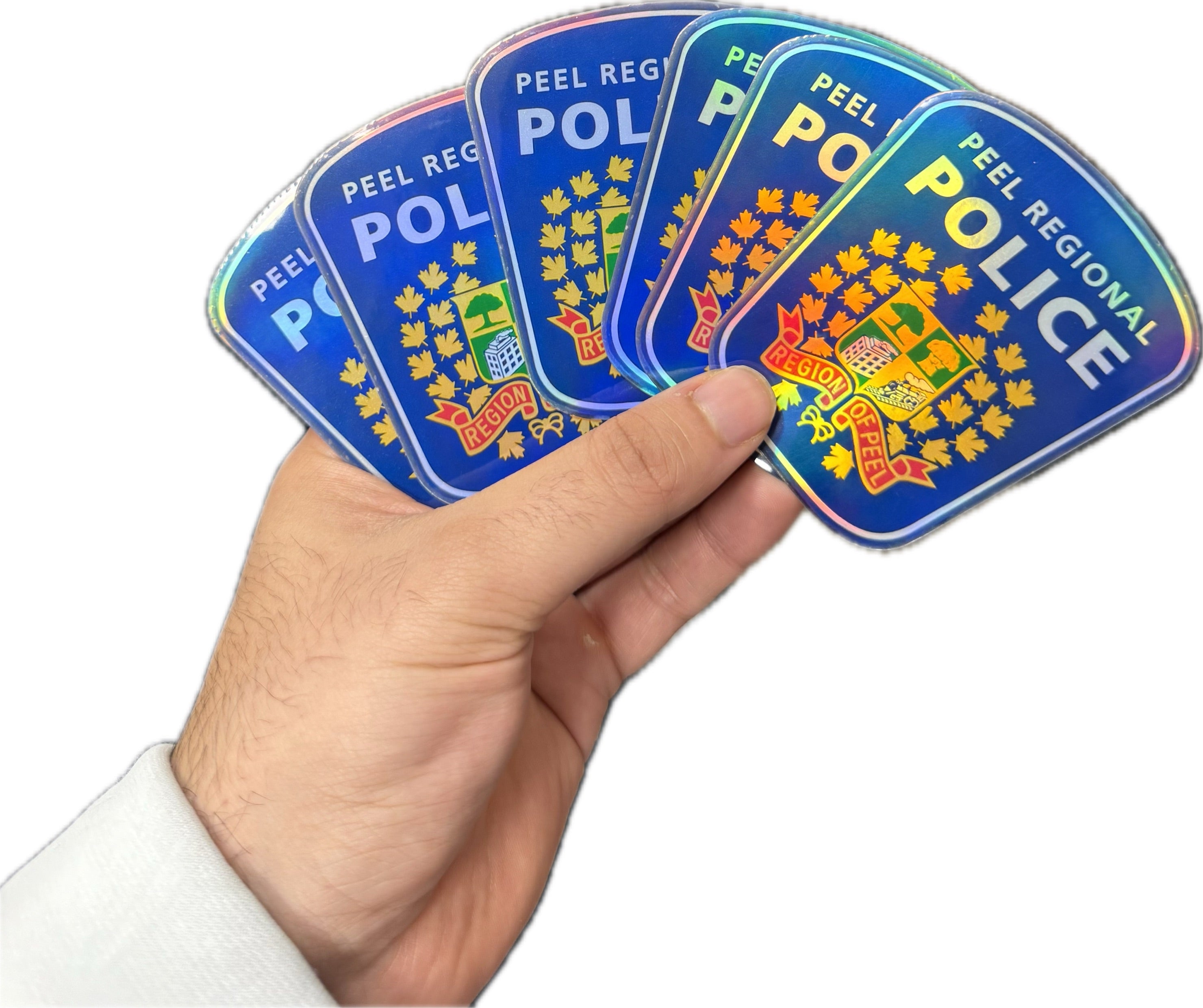 Holographic Peel Regional Police stickers fanned out in hand